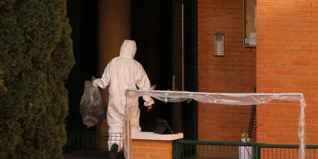 A worker wearing a romper and gloves carries a bag as he enters the apartment building of a Spanish nurse infected with Ebola in Madrid, Spain, Wednesday, Oct. 8, 2014. Three more people were placed under quarantine for Ebola at a Madrid hospital where the Spanish nurse became infected, authorities said Thursday. More than 50 other possible contacts were being monitored. The nurse, who had cared for a Spanish priest who died of Ebola, was the first case of Ebola being transmitted outside of West Africa, where a months-long outbreak has killed at least 3,500 people and infected at least twice as many. (AP Photo/Andres Kudacki)