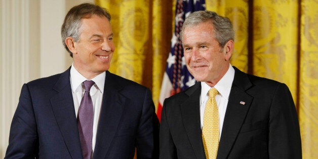 President George W. Bush and former British Prime Minister Tony Blair nudge each other in the East Room of the White House in Washington, Tuesday, Jan. 13, 2009, during a ceremony where the president presented Blair with the Presidential Medal of Freedom. (AP Photo/Gerald Herbert)