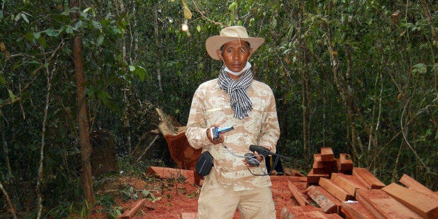 In this photo taken, Feb. 6, 2012, and released by The Cambodian Center for Human Rights (CCHR), Chut Wutty stands on wooden