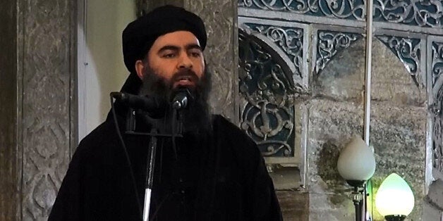 MOSUL, IRAQ - JULY 5 : An image grab taken from a video released on July 5, 2014 by Al-Furqan Media shows alleged Islamic State of Iraq and the Levant (ISIL) leader Abu Bakr al-Baghdadi preaching during Friday prayer at a mosque in Mosul.(Photo by Al-Furqan Media/Anadolu Agency/Getty Images)