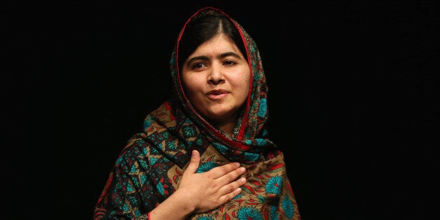 BIRMINGHAM, ENGLAND - OCTOBER 10: Malala Yousafzai acknowledges the crowd at a press conference at the Library of Birmingham after being announced as a recipient of the Nobel Peace Prize, on October 10, 2014 in Birmingham, England. The 17-year-old Pakistani campaigner, who lives in Britain where she received medical treatment following an assassination attempt by the Taliban in 2012, was jointly awarded the Nobel peace prize with Kailash Satyarthi from India. Chair of the Nobel Committee Thorbjorn Jagland made the announcement in Oslo, commending Malala for her Âheroic struggle as a spokesperson for girls' rights to education. (Photo by Christopher Furlong/Getty Images)