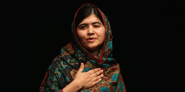 BIRMINGHAM, ENGLAND - OCTOBER 10: Malala Yousafzai acknowledges the crowd at a press conference at the Library of Birmingham after being announced as a recipient of the Nobel Peace Prize, on October 10, 2014 in Birmingham, England. The 17-year-old Pakistani campaigner, who lives in Britain where she received medical treatment following an assassination attempt by the Taliban in 2012, was jointly awarded the Nobel peace prize with Kailash Satyarthi from India. Chair of the Nobel Committee Thorbjorn Jagland made the announcement in Oslo, commending Malala for her Âheroic struggleÂ as a spokesperson for girls' rights to education. (Photo by Christopher Furlong/Getty Images)