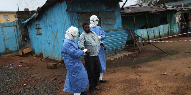 MONROVIA, LIBERIA - OCTOBER 13: Nurses escort Ebola survivor Wilson Weh, 56, from the JFK Ebola treatment center after he wa