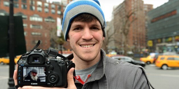 Brandon Stanton (L), creator of the Humans of New York blog, shows an image he took of a man named Carl February 22, 2013 across the street from Union Square in New York. Some like New York's skyscrapers, bridges, his energy, taxis or lights. But Brandon Stanton has set himself another challenge: photograph of 10,000 inhabitants for a blog now famous 'Humans of New York.' In two years, he has photographed 5,000 New Yorkers, children leaving school, tramps, fashionistas, New York with a bouquet of tulips, old lady with a cane, municipal employees, etc. And nearly 560,000 fans now follow his Facebook page.AFP PHOTO/Stan HONDA (Photo credit should read STAN HONDA/AFP/Getty Images)