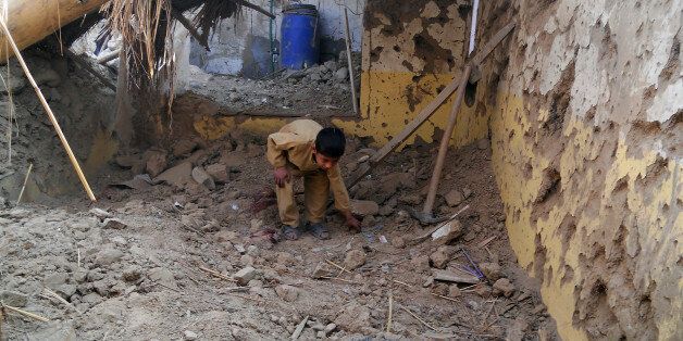 A Pakistani child sifts through rubble at a destroyed religious seminary belonging to the Haqqani network after a US drone strike in the Hangu district of Khyber Pakhtunkhwa province on November 21, 2013. A US drone strike targeting a base of the Haqqani militant network in northwest Pakistan killed six people in only the second such strike outside the country's lawless tribal districts. AFP PHOTO/SB SHAH (Photo credit should read SB SHAH/AFP/Getty Images)