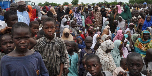 Civilians who fled their homes following an attack by Islamist militants in Bama, take refuge at a school in Maiduguri, Nigeria, Tuesday, Sept. 9, 2014. Fleeing residents say Boko Haram fighters are patrolling 50 kilometers (32 miles) of the main road between two of several towns the Islamic extremists have seized in a 200-mile (320-kilometer) arc running alongside northeast Nigeria's border with Cameroon. (AP Photo/Jossy Ola)