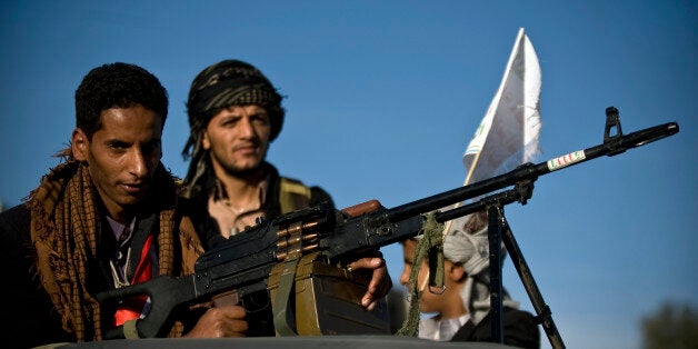 A Houthi Shiite rebel holds a weapon while on patrol following dawn prayers attended by supporters of the rebels on the first day of the Muslim holiday of Eid al-Adha, or Feast of the Sacrifice, in Sanaa, Yemen, Saturday, Oct. 4, 2014. Muslims around the world celebrated Saturday to commemorate the willingness of the prophet Ibrahim - or Abraham as he is known in the Bible - to sacrifice his son in accordance with God's will, though in the end God provides him a sheep to sacrifice instead. Muslims slaughter sheep, cattle, and other livestock, and give part of the meat to the poor. (AP Photo/Hani Mohammed)