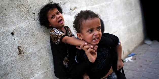 Children mourn during the funeral of two brothers 16-year-old Omar and 12-year-old Mohammed Breem, who were killed by an Israeli airstrike yesterday ahead of long-term truce agreed between Israel and the Palestinians, in Khan Younis in the southern Gaza Strip on August 27, 2014. The skies over Gaza remained calm as a long-term ceasefire took hold, ending the deadliest violence in a decade with Israel and Hamas both claiming 'victory' in the 50-day war. AFP PHOTO/SAID KHATIB (Photo credit should read SAID KHATIB/AFP/Getty Images)