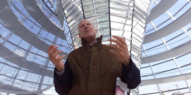 British architect Sir Norman Foster guides a media tour through the glass dome of the "Reichstag", Germany's parliament building in Berlin, Wednesday, April 14, 1999. On April 19th, 1999 the parliament will have its first session in the 19th century building which was renovated by Foster. The parliament will move to Berlin in summer 1999. Embargoed until Monday, April 19, 1999, 11 gmt. (AP Photo/Jockel Finck)