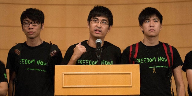 HONG KONG - OCTOBER 21: Hong Kong Federation of Students Secretary-General Alex Chow(C) speaks to the media after a meeting w
