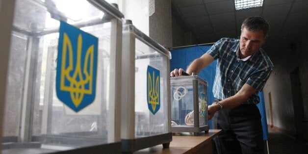 A member of the election commission prepares ballot boxes at one of the polling stations in Kiev on May 24, 2014, a day before the presidential election in Ukraine. Ukraine was counting down today to a presidential election seen as crucial to its very survival after months of turmoil that has driven the country to the brink of civil war. AFP PHOTO / ANATOLII STEPANOV (Photo credit should read ANATOLII STEPANOV/AFP/Getty Images)