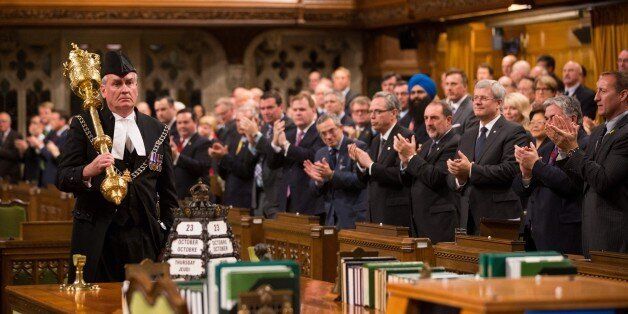 OTTAWA, CANADA - OCTOBER 23: In this handout photo provided by the PMO, Prime Minister Stephen Harper (R) and all Members of Parliament applaud Kevin Vickers, Sergeant-at-Arms, during the reopening of Parliament on October 23, 2014 in Ottawa, Canada. The gunman, identified as Michael Zehaf-Bibeau, was shot and killed by Kevin Vickers while still inside the Parliament building. (Photo by Jason Ransom/PMO via Getty Images)
