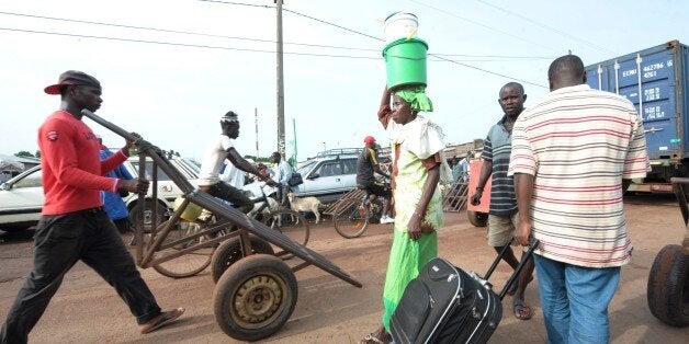 TO GO WITH AFP STORY BY MALICK ROKHY BA
People walk on September 3, 2014 on the usually busy main market road in the norther