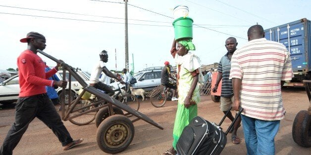 TO GO WITH AFP STORY BY MALICK ROKHY BAPeople walk on September 3, 2014 on the usually busy main market road in the northern Senegalese city of Diaobe, one of the most important trading cities in West Africa. The busy market street is near empty since the August 21 closure of the border with Guinea since a Guinean student brought the deadly Ebola epidemic raging across west Africa into Senegal. The Ebola virus, passed on through contact with infected bodily fluids, has killed more than 2,000 in Guinea, Sierra Leone and Liberia. Nigeria became the fourth country caught up in the epidemic, reporting seven deaths before Senegal registered its first case. AFP PHOTO / SEYLLOU (Photo credit should read SEYLLOU/AFP/Getty Images)