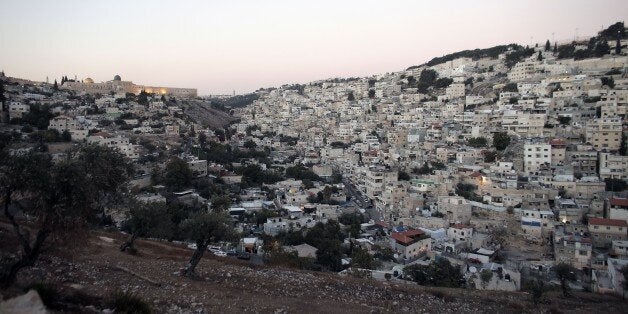 A picture taken on October 21, 2014 shows the Dome of the Rock in the Al-Aqsa mosque compound (L) and the east Jerusalem neig