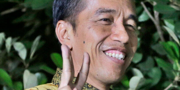 Indonesian President-elect Joko Widodo gestures during a press conference at his residence in Jakarta, Indonesia, Thursday, A