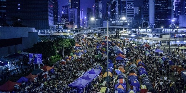 Pro-democracy protester gather at the main protest site in the Admiralty district of Hong Kong on October 24, 2014. Major intersections in the southern Chinese city have been paralysed by mass rallies demanding free elections for more than three weeks, in one of the biggest challenges to Beijing's authority since the Tiananmen pro-democracy protests of 1989. AFP PHOTO / Philippe Lopez (Photo credit should read PHILIPPE LOPEZ/AFP/Getty Images)