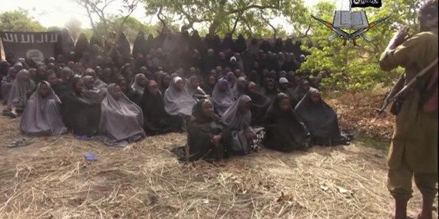 FILE - This file photo taken from video by Nigeria's Boko Haram terrorist network, Monday, May 12, 2014, shows the missing girls alleged to be abducted April 14, from the northeastern town of Chibok. A Nigerian government official said "all options are open" in efforts to rescue the almost 300 abducted schoolgirls from their Islamic extremist captors as U.S. surveillance and reconnaissance aircraft started flying over the West African country. (AP Photo/File)
