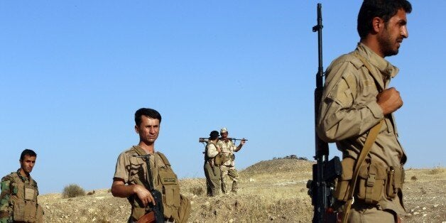 Iraqi Peshmerga fighters take position at a post near the jihadist-held city of Zumar in Mosul province on September 4, 2014.