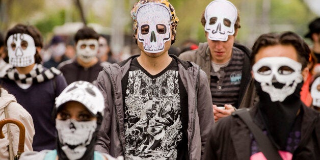 People wearing masks of skulls protest against violence in the country, in Mexico City on November 27, 2011. More than 40.000 people have been killed in rising drug-related violence in Mexico since December 2006, when President Felipe Calderon deployed soldiers and federal police to take on organized crime. AFP PHOTO/Alfredo Estrella (Photo credit should read ALFREDO ESTRELLA/AFP/Getty Images)