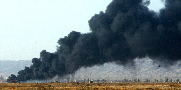 The thick black smoke from an oil pipeline fire in Baji 38 kilometers, 23 miles from Tikrit, Iraq, Thursday, Sept. 18, 2003, drifts slowly across the countryside. The oil fire which began late Wednesday, with firefighters and engineers at the site said they believed it was the work of saboteurs.