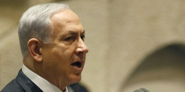 Israeli Prime Minister Benjamin Netanyahu delivers a speech at the Knesset, Israel's parliament, on October 29, 2014 in Jerusalem. An article published online by The Atlantic magazine quoted officials of US President Barack Obama's administration as calling Netanyahu a 'chickenshit' and attacking him over Israeli policy on settlement building in the occupied Palestinian territories. AFP PHOTO/GALI TIBBON (Photo credit should read GALI TIBBON/AFP/Getty Images)