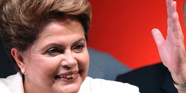 Re-elected Brazilian President Dilma Rousseff delivers a speech following her win, in Brasilia on October 26, 2014. Leftist incumbent Dilma Rousseff was re-elected president of Brazil, the country's Supreme Electoral Tribunal said, after a down-to-the-wire race against center-right challenger Aecio Neves. Rousseff, who had 51.45 percent of the vote with 98 percent of ballots counted, was declared the run-off winner. AFP PHOTO / EVARISTO SA (Photo credit should read EVARISTO SA/AFP/Getty Images)