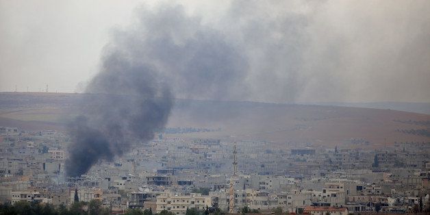 SANLIURFA, TURKEY - OCTOBER 28: Smoke, rising from Ayn al-Arab (Kobani) during the clashes between Islamic State of Iraq and Levant (ISIL) and armed groups, is seen from Suruc district of Turkey's Sanliurfa on October 28, 2014. (Photo by Sercan Kucuksahin/Anadolu Agency/Getty Images)