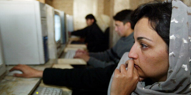 KABUL, AFGHANISTAN -JANUARY 20: An Afghan woman uses a computer at the Park Residence Internet Cafe on January 20, 2003 in Kabul, Afghanistan. The Internet cafe opened 40 days ago and already is doing a booming business with foreigners and Afghans alike. It claims to be the first privately owned Internet cafe in Afghanistan. (Photo by Paula Bronstein/Getty Images)