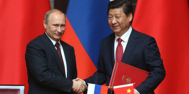 SHANGHAI, CHINA - MAY 20: Russian President Vladimir Putin (L) and Chinese President Xi Jingping (R) attend a welcoming ceremony on May 20, 2014 in Shanghai, China. Putin is on a two day visit to China (Photo by Sasha Mordovets/Getty Images)