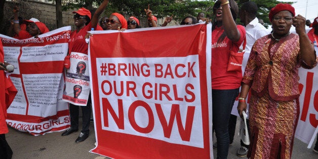 FILE - In this file photo taken Tuesday, Oct. 14, 2014, people demonstrate calling on the Nigerian government to rescue girls