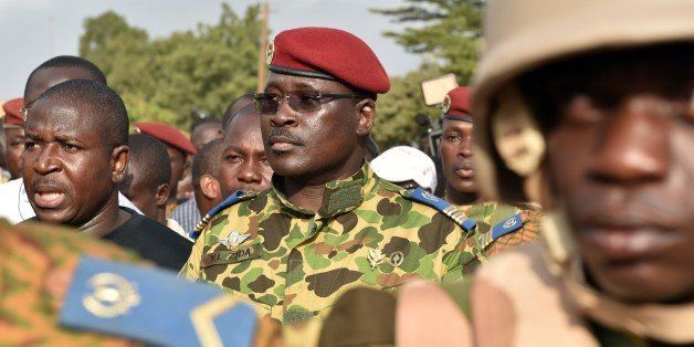 Lieutenant-Colonel Yacouba Issaac Zida (C) arrives at the Place de la Nation square on October 31, 2014 in Ouagadougou after the resignation of Burkina Faso's President Blaise Compaore. The deposed president of Burkina Faso, Blaise Compaore, is 'in a safe place' and his 'safety and well-being are assured', Colonel Isaac Zida, second in command of the presidential guard, said on November 1st. Zida, who had just declared himself head of state, told journalists that Compaore, who resigned on October 31, and his chief of staff 'are in a safe place and their safety and well-being are assured.' AFP PHOTO / ISSOUF SANOGO (Photo credit should read ISSOUF SANOGO/AFP/Getty Images)