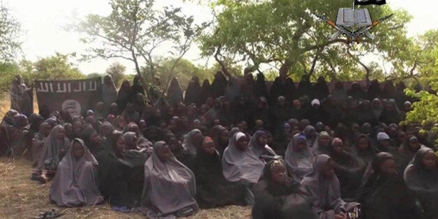 FILE - This Monday May 12, 2014 file image taken from video by Nigeria's Boko Haram terrorist network, shows the alleged missing girls abducted from the northeastern town of Chibok. Nigeriaâs government and Islamic extremists from Boko Haram have agreed to an immediate cease-fire, officials said Friday Oct. 17, 2014. The fate of more than 200 missing schoolgirls abducted by the insurgents six months ago remains unclear. Defense Ministry spokesman Maj. Gen. Chris Olukolade said their release is still being negotiated. (AP Photo/File)