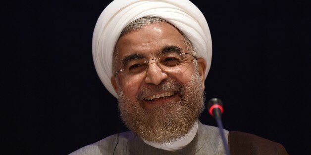 Iranian President Hassan Rouhani smiles before answering a question during press conference in New York on September 26, 2014. Rouhani said Friday that talks with international powers on Tehran's nuclear program must move forward more quickly, saying limited progress had been made in recent days. 'The remaining time for reaching an agreement is extremely short. Progress that has been witnessed in the last few days has been extremely slow,' he told reporters in New York, where he attended the UN General Assembly. AFP PHOTO/Jewel Samad (Photo credit should read JEWEL SAMAD/AFP/Getty Images)