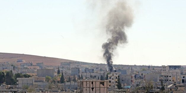 SANLIURFA, TURKEY - NOVEMBER 5: Smoke rising during the clashes between Islamic State of Iraq and Levant (ISIL) members and armed groups in Ayn al Arab (Kobani), is seen from Suruc district of Sanliurfa, Turkey on November 5, 2014. (Photo by Ahmet Okatali/Anadolu Agency/Getty Images)