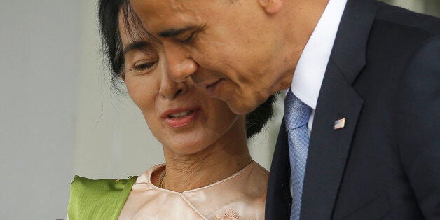U.S. President Barack Obama, right, walks out with Myanmar opposition leader Aung San Suu Kyi after addressing members of the