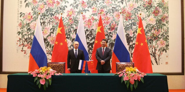 BEIJING, CHINA - NOVEMBER 9: Russian President Vladimir Putin and Chinese President Xi Jinping attend a Bilateral Meeting at the Diaoyutai State Guesthouse during the Asia-Pacific Economic Cooperation (APEC) summit on November 9, 2014 in Beijing, China. 2014 APEC Economic Leaders' Meetings and APEC summit is being held at Beijing's outskirt Yanqi Lake. (Photo by How Hwee Young - Pool/Getty Images)