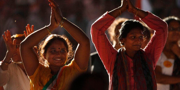 Supporters of Indian yoga guru Baba Ramdev applaud at an anti-corruption protest in New Delhi, India, Sunday, Aug. 12, 2012.