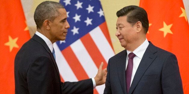 U.S. President Barack Obama, left, and Chinese President Xi Jinping shake hands following the conclusion of their joint news