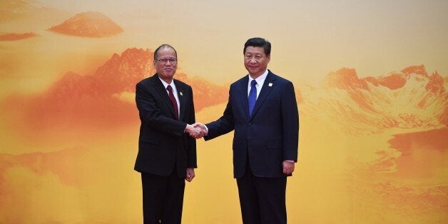 Philippine President Benigno Aquino (L) shakes hands with China's President Xi Jinping as he arrives for the Asia-Pacific Economic Cooperation (APEC) leaders meeting at Yanqi Lake, north of Beijing on November 11, 2014. Top leaders and ministers of the 21-member APEC grouping are meeting in Beijing from November 7 to 11. AFP PHOTO / Greg BAKER (Photo credit should read GREG BAKER/AFP/Getty Images)