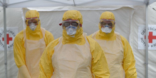 WUERZBURG, GERMANY - OCTOBER 07: Volunteer doctors who will travel to West Africa to help care for Ebola patients waiting for desinfection during training offered by the German Red Cross (DRK) on October 7, 2014 in Wuerzburg, Germany. Over 1,200 people across Germany have responded to a DRK call for volunteers, while the German armed forces, the Bundeswehr, has also asked for volunteers from its own ranks. Countries around the world are taking increasing precautions and committing resources in the battle against the deadly virus as the number of victims continues to climb. (Photo Timm Schamberger/Getty Images)