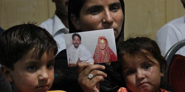 LAHORE, PUNJAB, PAKISTAN - 2014/05/31: Khalida Perveen elder sister of the late Farzana Perveen, holds a picture which according to Bibi is of Farzana's first marriage with her cousin Mazhar Iqbal during a news conference in Lahore. Pakistani police investigating the murder of a woman bludgeoned to death outside a court have arrested four men, a senior officer said, as her husband said he wanted her killers to 'die in pain'. (Photo by Rana Sajid Hussain/Pacific Press/LightRocket via Getty Images)