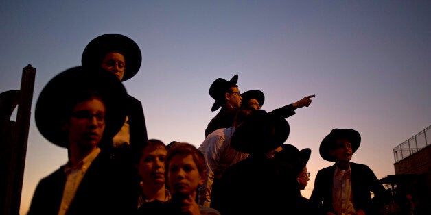 Israelis and relatives attend the funerals of Aryeh Kupinsky, Cary William Levine, and Avraham Goldberg, three of the four people killed in a shooting attack in a synagogue in Jerusalem, Tuesday, Nov. 18, 2014. Two Palestinian cousins armed with meat cleavers and a gun stormed a Jerusalem synagogue during morning prayers Tuesday, killing four people in the cityâs bloodiest attack in years. Police killed the attackers in a shootout. (AP Photo/Ariel Schalit)