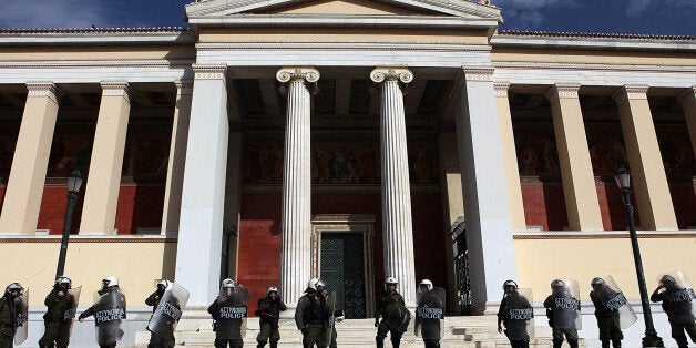 ATHENS, GREECE - NOVEMBER 13: Greek security forces stand guard in front of the Parliament building on November 13, 2014 during a demonstration on the anniversary of 1973 student uprising against the military junta on November 17, in Athens, Greece. After Theodoros Forcakis, rector of Athens University, decided to close the entrance of the faculties to prevent the protests, students and the dismissed administrative personnels marched to Syntagma Square. (Photo by Ayhan Mehmet/Anadolu Agency/Getty Images)