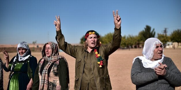 Kurdish women shout slogans as they demonstrate in the southeastern border village of Mursitpinar, Sanliurfa province, on November 9, 2014, near the Syrian town of Kobane, also known as Ain al-Arab. More than 1,000 people, mostly jihadists, have been killed in Kobane since the Islamic State group launched an offensive on the Syrian town on September 16. Kobane's Kurdish defenders have been joined by Syrian rebels as well as by Iraqi Kurd peshmerga forces, to repel IS militants from the city. AFP PHOTO / ARIS MESSINIS (Photo credit should read ARIS MESSINIS/AFP/Getty Images)