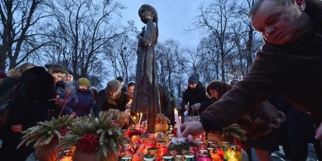 People place candles in memory of the victims of the Holodomor famine during a ceremony at the Holodomor memorial in Kiev on November 22, 2014. Ukraine marked 81 years since the Stalin-era Holodomor famine, one of the darkest pages in its entire history that left millions dead and which is regarded by many as a genocide. The 1932-33 famine took place as harvests dwindled and Soviet leader Josef Stalin's police enforced the brutal policy of collectivising agriculture by requisitioning grain and other foodstuffs. AFP PHOTO/ SERGEI SUPINSKY (Photo credit should read SERGEI SUPINSKY/AFP/Getty Images)