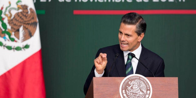 Mexico's President Enrique Pena Nieto speaks during a ceremony at the National Palace in Mexico City, Thursday, Nov. 27, 2014. Mexico's president announced a new anti-crime plan that includes proposals for a nationwide ID, giving Congress the power to dissolve corrupt municipal government and fold their often-corrupt local police forces under the control of the countryâs 31 state governments. The plan would also streamline the complex divisions between federal, state and local offenses. At present, some local police refuse to act to prevent federal crimes like drug trafficking. The plan would focus first on four of Mexicoâs most troubled states, Guerrero, Michoacan, Jalisco and Tamaulipas. It would also send more federal police and other forces to those states. (AP Photo/Eduardo Verdugo)