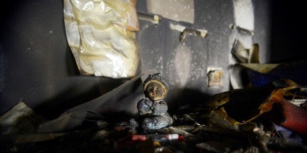 Damages are seen in a classroom of a bilingual Hebrew and Arabic school in Jerusalem, Sunday, Nov. 30, 2014. A police spokeswoman said the fire was set Saturday night to a classroom in the Jerusalem school, which has both Jewish and Arab students. Graffiti was found on the walls reading "death to Arabs." (AP Photo/Mahmoud Illean)