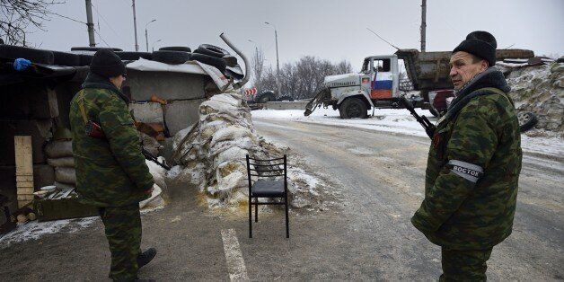 Pro-russian fighters man a checkpoint near the airport in the Kievsky district of the eastern Ukraine city of Donetsk on November 28, 2014. The pro-Russian separatists defied the Ukrainian government on November 2 when they held leadership elections in the east of the country that they described as legitimising their two self-declared independent states. AFP PHOTO / ERIC FEFERBERG (Photo credit should read ERIC FEFERBERG/AFP/Getty Images)