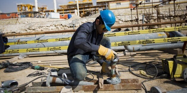 An Iranian man works at the phase 19 of the South Pars gas field facilities near the southern town of Kangan on the shore of the Gulf on January 22, 2014. South Pars, a huge offshore natural gas field shared between Iran and Qatar, holds around 14 trillion cubic metres of gas. AFP PHOTO/BEHROUZ MEHRI (Photo credit should read BEHROUZ MEHRI/AFP/Getty Images)